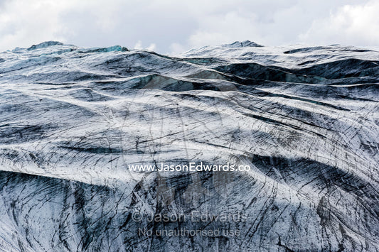 Lines scar the ice on the inhospitable surface of a glacier. Isunnguata Sermia Glacier, Kangerlussuaq, Qeqqata Municipality, Greenland.