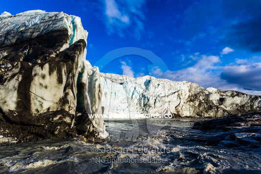 Erosion from ice against rock deposits silt and soil sediment on the face of a glacier fracture zone. Qinnguata Kuussua River, Russell Glacier, Greenland Ice Sheet, Qeqqata Municipality, Kangerlussuaq, Greenland.