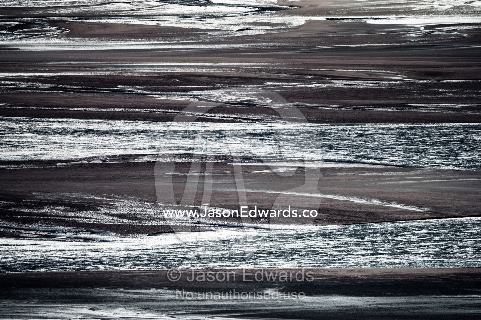 Sunrays illuminate a vast river floodplain carrying glacier run-off that creates quicksand plains. Qinnguata Kuussua River, Russell Glacier, Greenland Ice Sheet, Qeqqata Municipality, Kangerlussuaq, Greenland.
