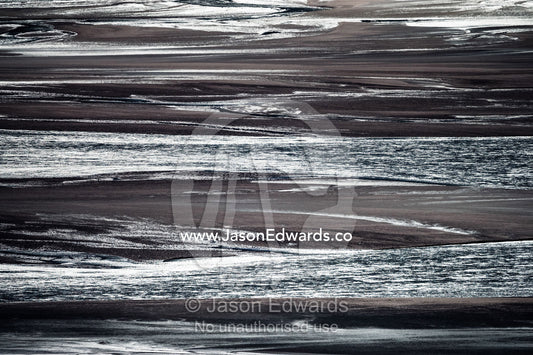 Sunrays illuminate a vast river floodplain carrying glacier run-off that creates quicksand plains. Qinnguata Kuussua River, Russell Glacier, Greenland Ice Sheet, Qeqqata Municipality, Kangerlussuaq, Greenland.