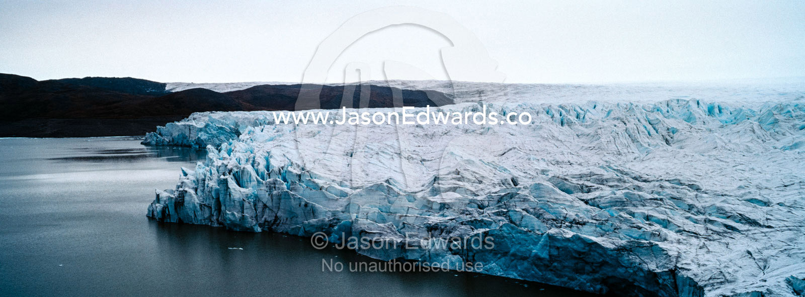 The fracture zone of a glacier on the Greenland Ice Sheet ending in a lake. Greenland Ice Sheet, Qeqqata Municipality, Kangerlussuaq, Greenland.