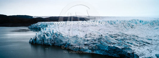 The fracture zone of a glacier on the Greenland Ice Sheet ending in a lake. Greenland Ice Sheet, Qeqqata Municipality, Kangerlussuaq, Greenland.
