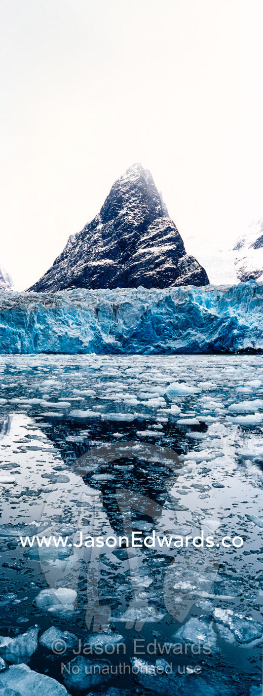 The sheer fracture zone of a glacier sandwiched between alpine peaks in a fjord. Fjord of Eternity, Maniitsoq, Sukkertoppen, Qeqqata Municipality, Greenland.