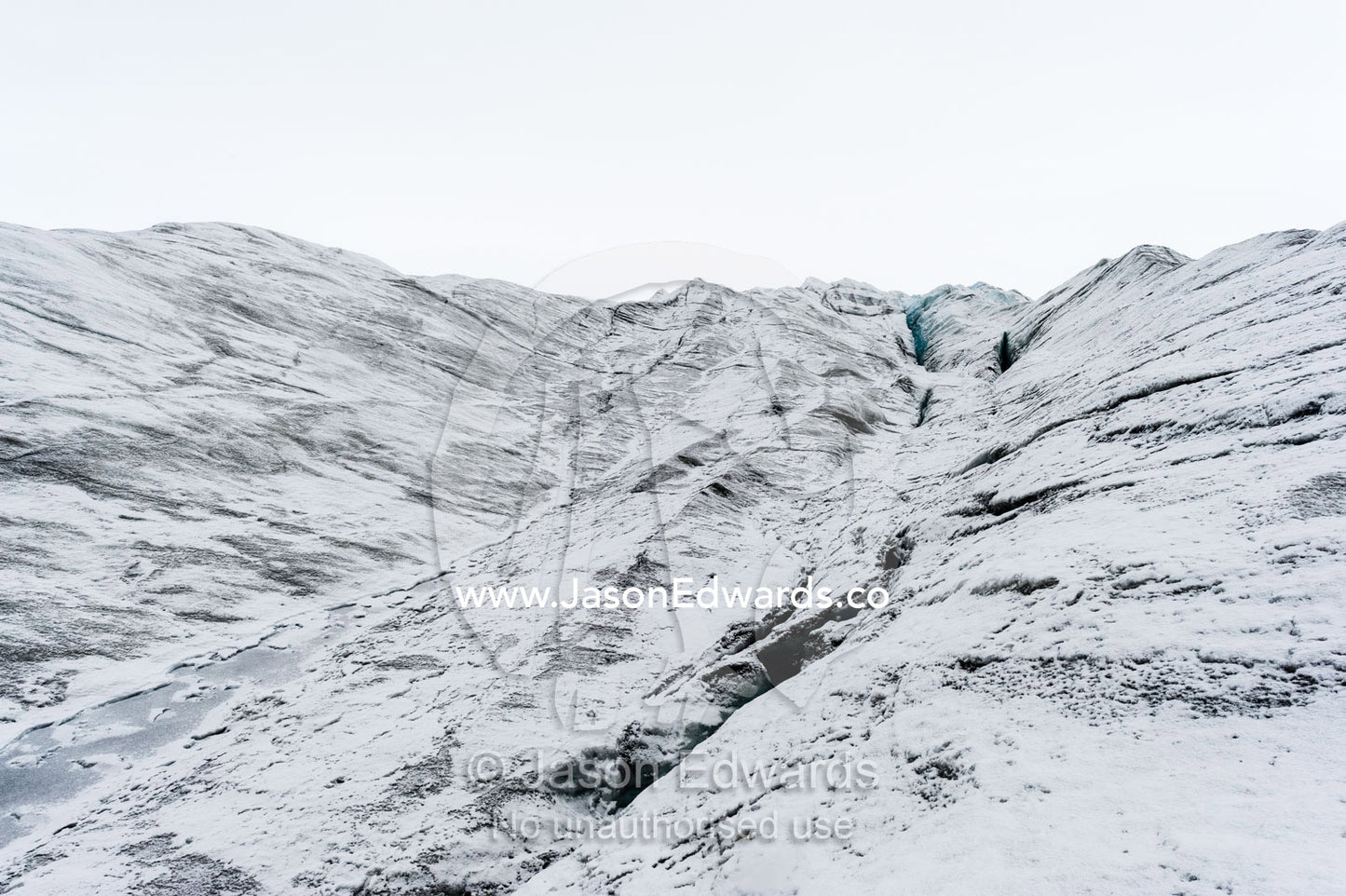 The frozen and barren wasteland of folded ice on the surface of the Greenland Ice Sheet. Greenland Ice Sheet, Qeqqata Municipality, Kangerlussuaq, Greenland.