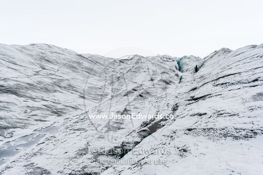 The frozen and barren wasteland of folded ice on the surface of the Greenland Ice Sheet. Greenland Ice Sheet, Qeqqata Municipality, Kangerlussuaq, Greenland.