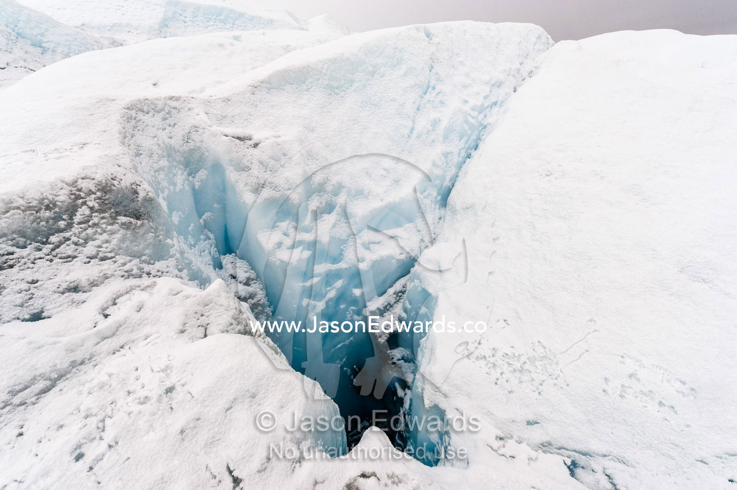 A moulin is a narrow, tubular chute or crevasse through which water enters a glacier from the surface. Greenland Ice Sheet, Qeqqata Municipality, Kangerlussuaq, Greenland.