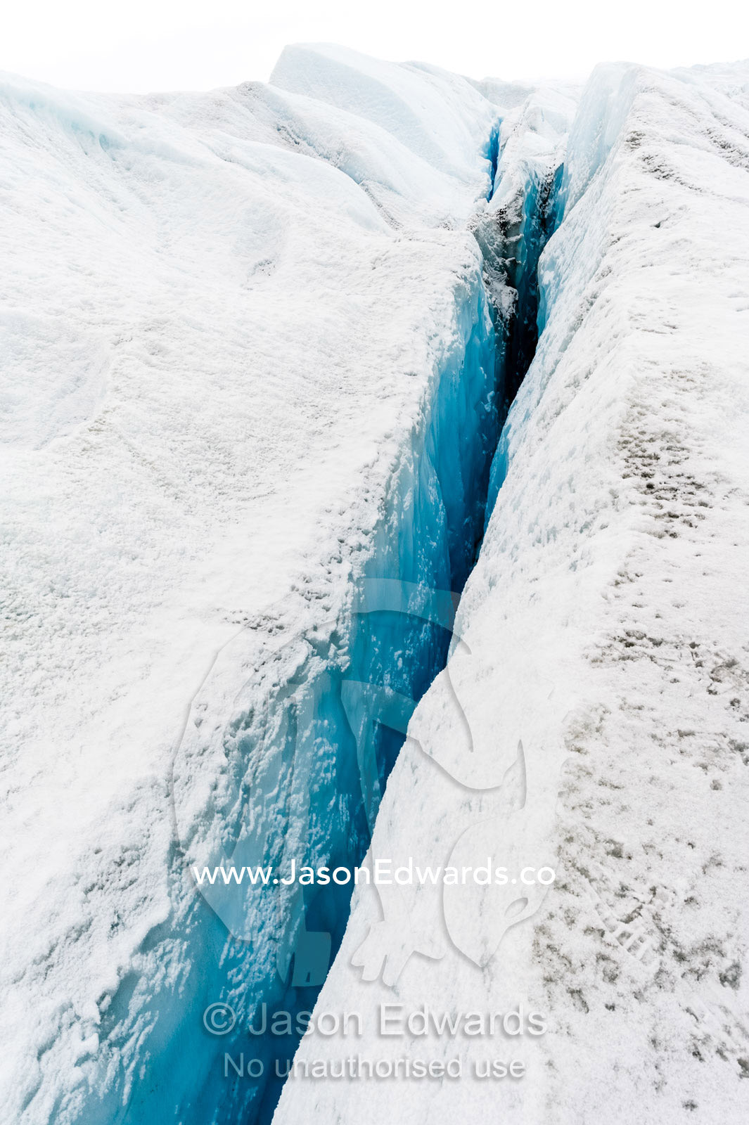 The sheer walls of a crevasse on the surface of the Greenland Ice Shelf. Greenland Ice Sheet, Qeqqata Municipality, Kangerlussuaq, Greenland.