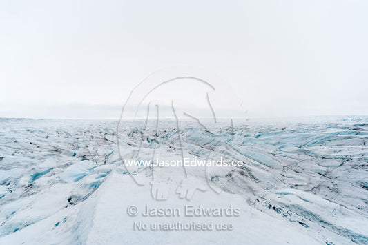 The frozen and barren wasteland of folded ice on the surface of the Greenland Ice Sheet. Greenland Ice Sheet, Qeqqata Municipality, Kangerlussuaq, Greenland.