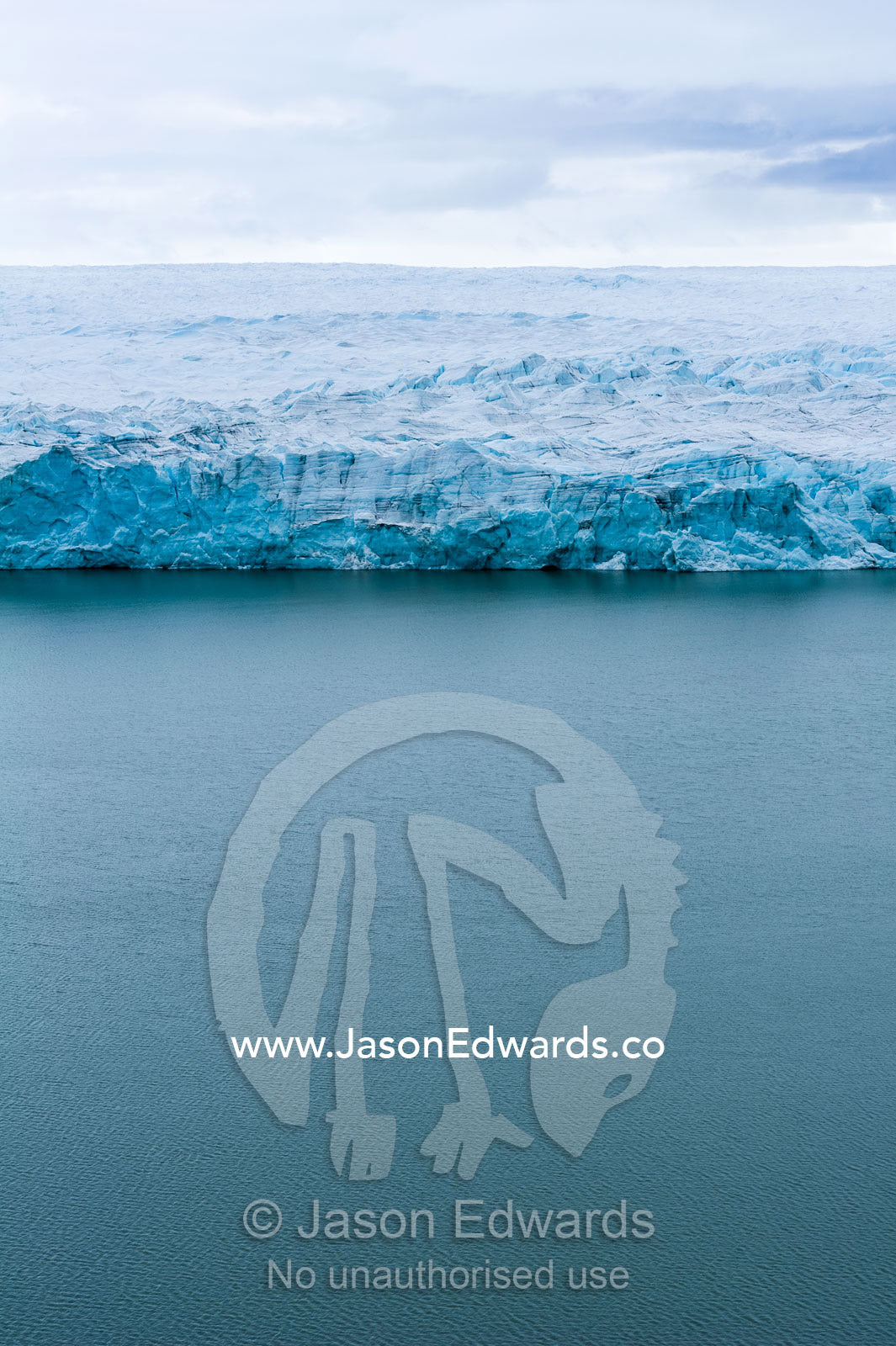The ice fracture zone of a glacier on the Greenland Ice Sheet ending in a lake. Greenland Ice Sheet, Qeqqata Municipality, Kangerlussuaq, Greenland.