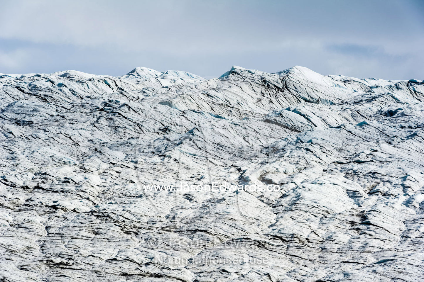 A lunar landscape of tortured layers of ice on the surface of a glacier. Isunnguata Sermia Glacier, Kangerlussuaq, Qeqqata Municipality, Greenland.