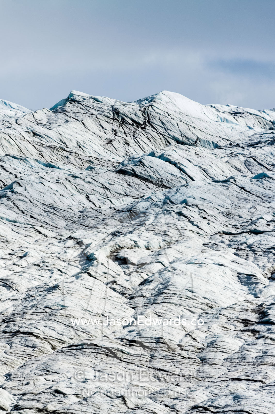 A lunar landscape of tortured layers of ice on the surface of a glacier. Isunnguata Sermia Glacier, Kangerlussuaq, Qeqqata Municipality, Greenland.