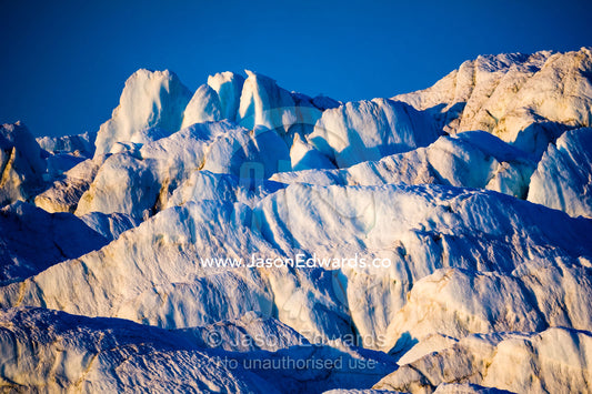 Pastel hues across a field of crevasse and pressure ridges in the fracture zone of a glacier. Russell Glacier, Greenland Ice Sheet, Qeqqata Municipality, Kangerlussuaq, Greenland.