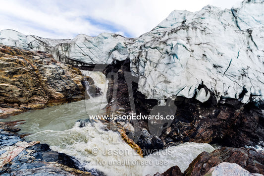 A waterfall of meltwater cascades from beneath a glacier fracture zone. Qinnguata Kuussua River, Russell Glacier, Greenland Ice Sheet, Qeqqata Municipality, Kangerlussuaq, Greenland.