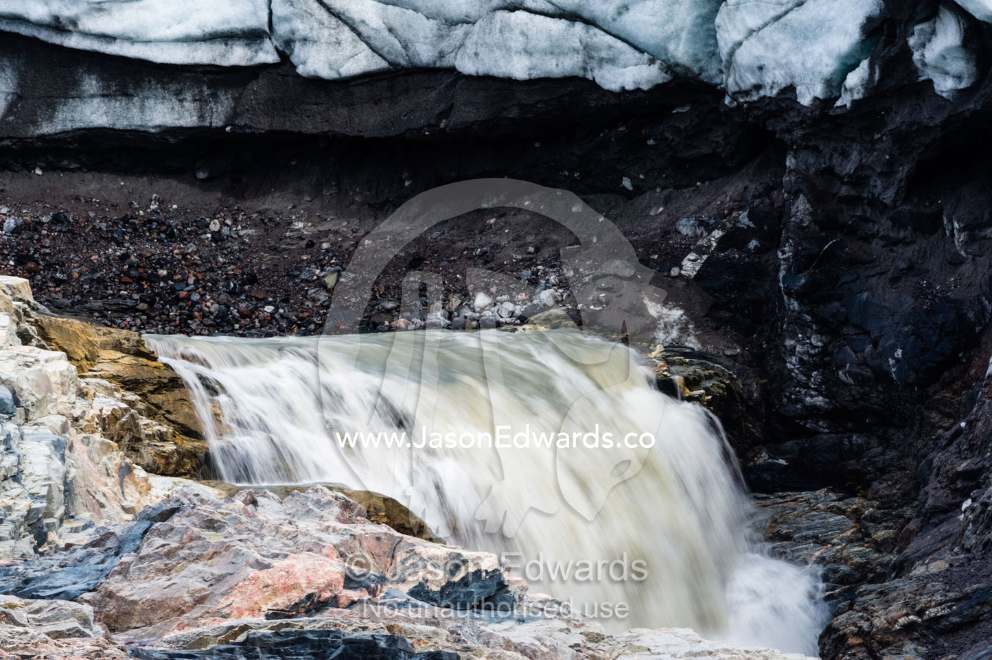 A waterfall of meltwater cascades from beneath a glacier fracture zone. Qinnguata Kuussua River, Russell Glacier, Greenland Ice Sheet, Qeqqata Municipality, Kangerlussuaq, Greenland.