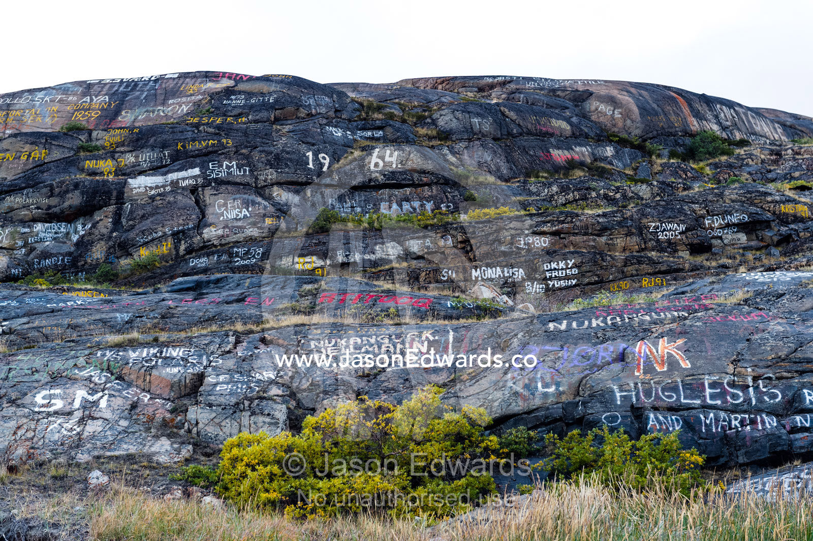 Graffiti on a cliff face near an arctic village. Kangerlussuaq Port, Kangerlussuaq Fjord, Kangerlussuaq, Qeqqata Municipality, Greenland.