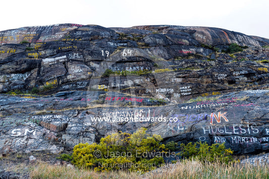 Graffiti on a cliff face near an arctic village. Kangerlussuaq Port, Kangerlussuaq Fjord, Kangerlussuaq, Qeqqata Municipality, Greenland.