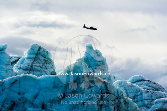 An airforce Hercules aircraft flying over the Greenland Ice Sheet. Russell Glacier, Greenland Ice Sheet, Qeqqata Municipality, Kangerlussuaq, Greenland.