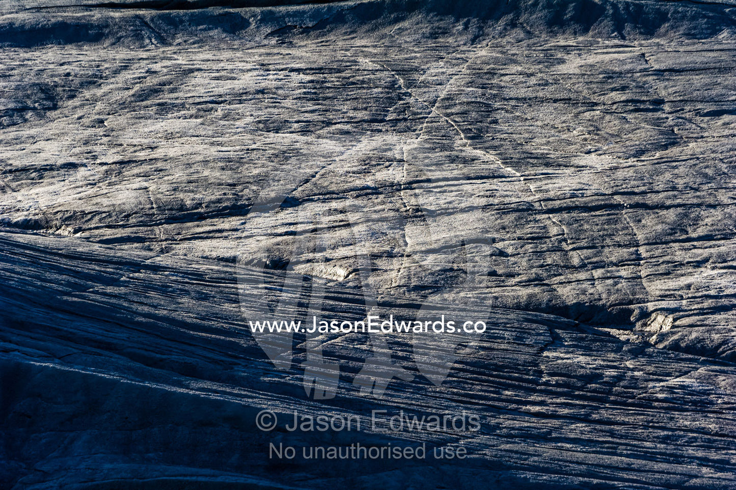 Erosion from ice against rock deposits silt and soil sediment on the surface of a glacier. Russell Glacier, Greenland Ice Sheet, Qeqqata Municipality, Kangerlussuaq, Greenland.