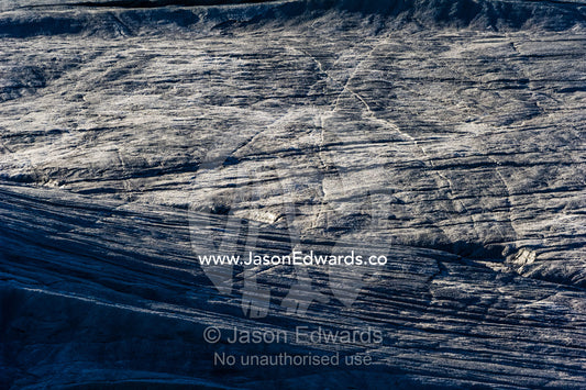Erosion from ice against rock deposits silt and soil sediment on the surface of a glacier. Russell Glacier, Greenland Ice Sheet, Qeqqata Municipality, Kangerlussuaq, Greenland.