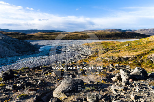 A river flowing along the fracture zone of an enormous glacier across a tundra plain. Qinnguata Kuussua River, Russell Glacier, Greenland Ice Sheet, Qeqqata Municipality, Kangerlussuaq, Greenland.