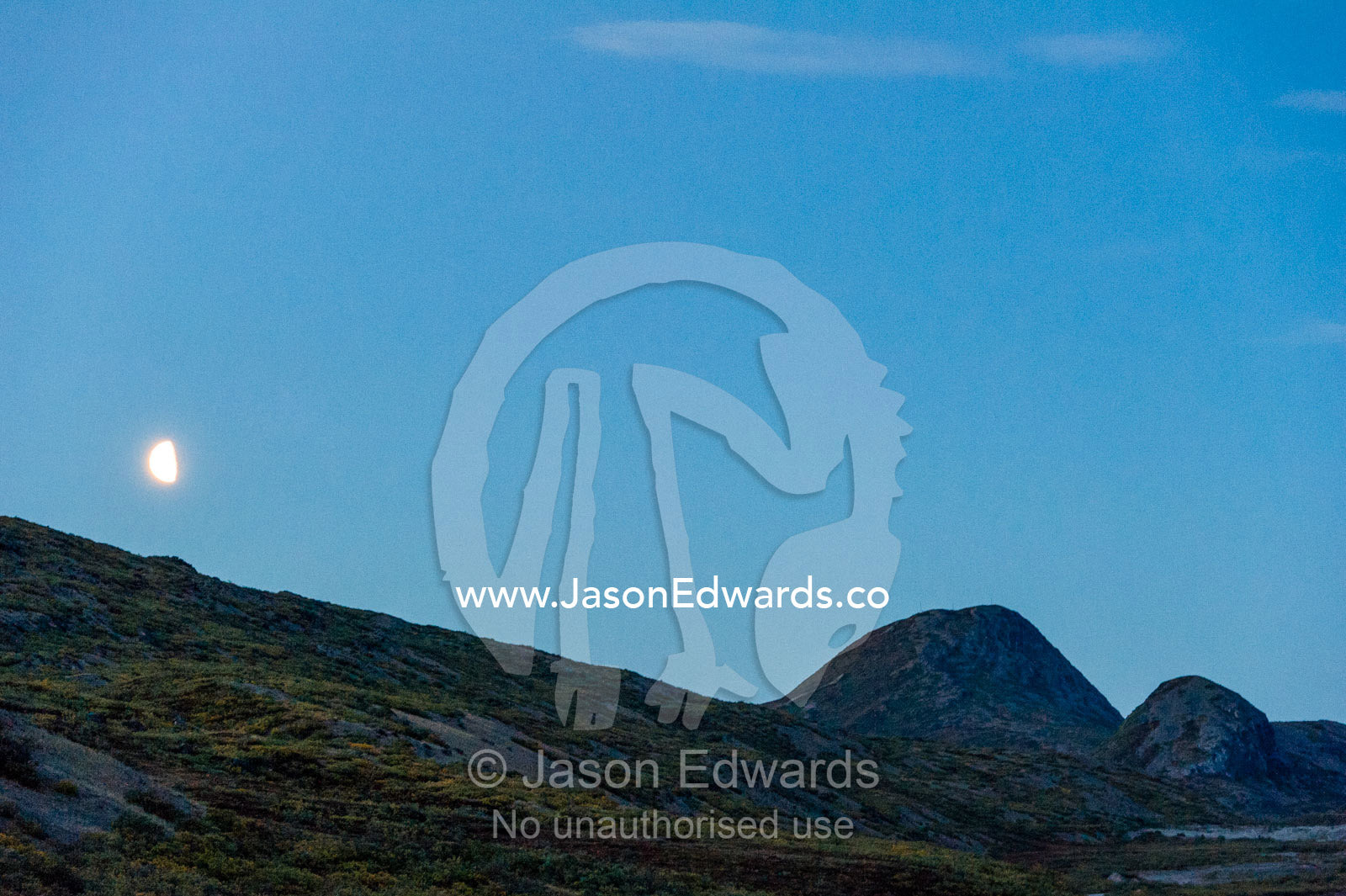Moonrise over Sugarloaf Mountain and a tundra ridge. Sugarloaf Mountain, Kangerlussuaq, Qeqqata Municipality, Greenland.