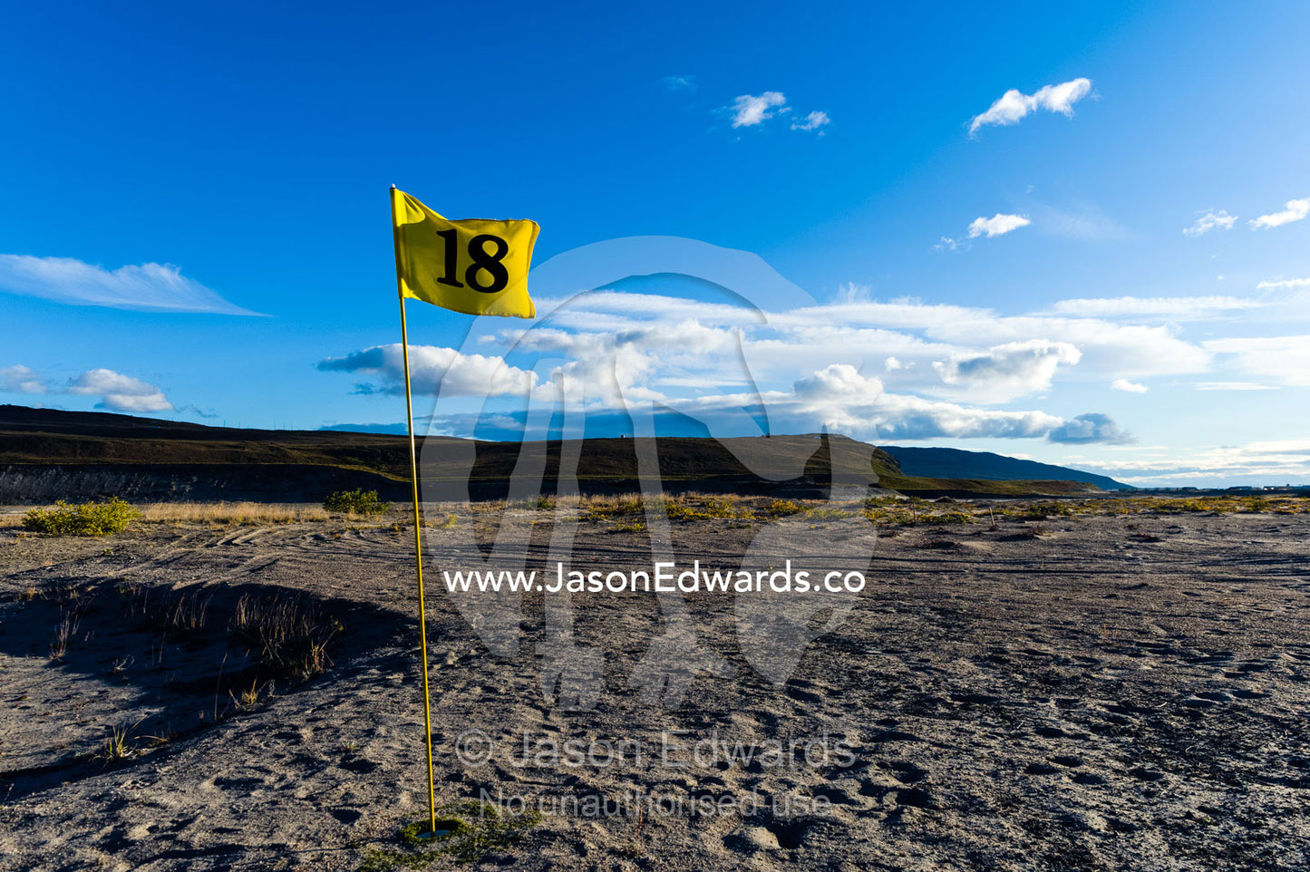 The 18th hole flag on a sand golf course in the arctic. Kangerlussuaq, Qeqqata Municipality, Greenland.