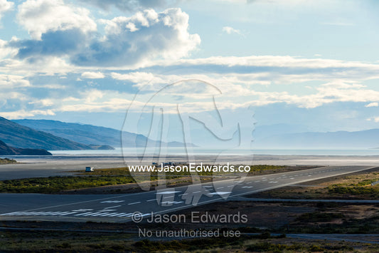 An airport tarmac facing a fjord in the arctic. Kangerlussuaq Airport, Kangerlussuaq, Qeqqata Municipality, Greenland.