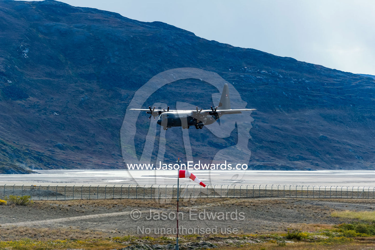 An airforce Hercules aircraft landing at an arctic airport. Kangerlussuaq Airport, Kangerlussuaq, Qeqqata Municipality, Greenland.
