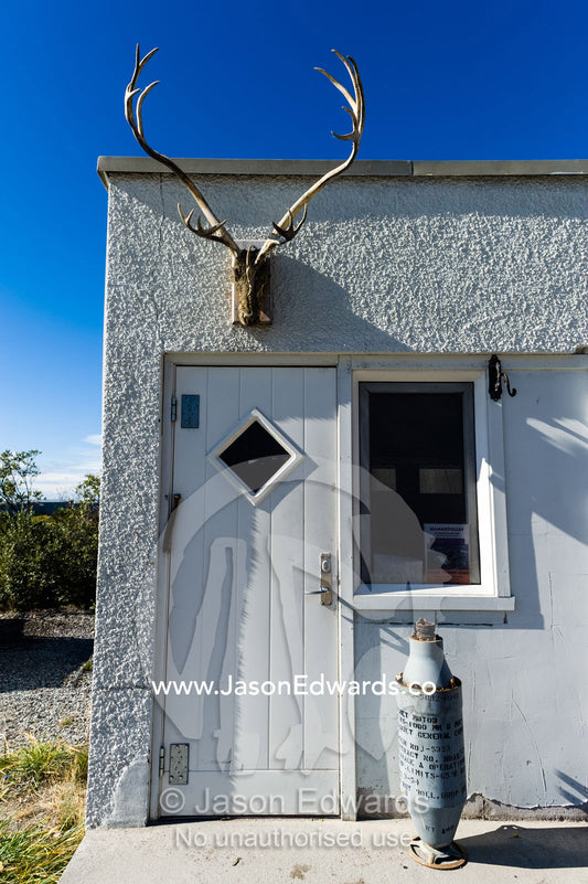 A Caribou skull mounted above a doorway in a village. Kangerlussuaq, Qeqqata Municipality, Greenland.