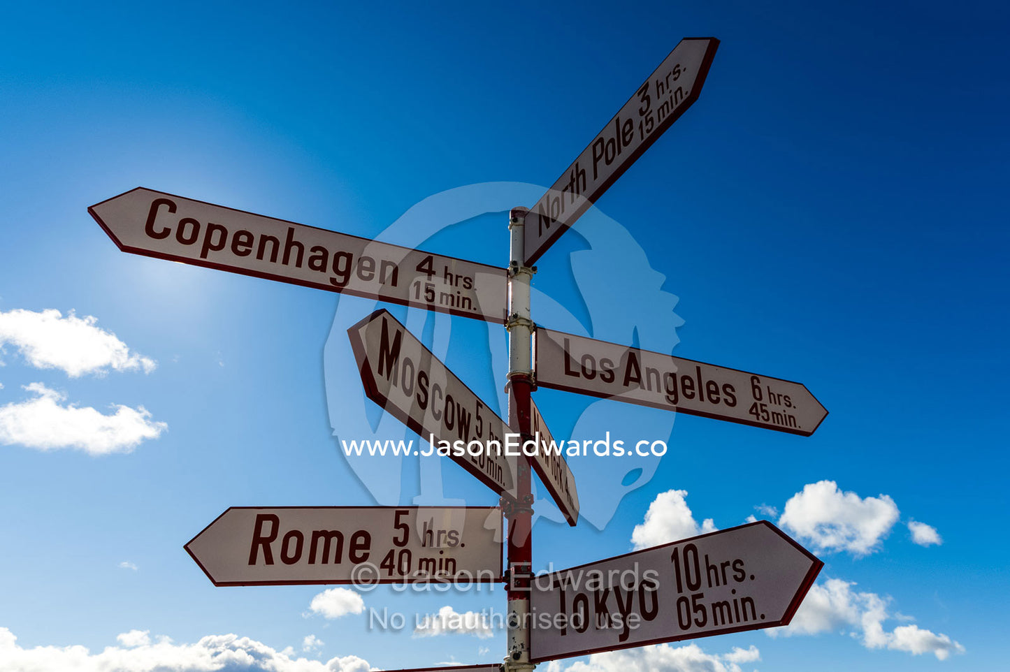 Directional signs pointing to cities around the world and their distance from Greenland. Kangerlussuaq, Qeqqata Municipality, Greenland.