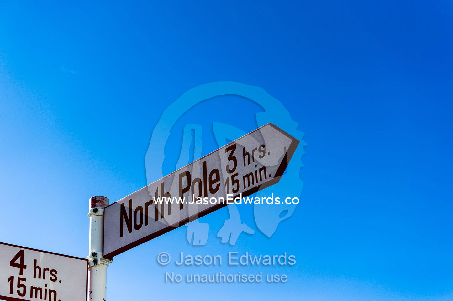 Directional signs pointing to cities around the world and their distance from Greenland. Kangerlussuaq, Qeqqata Municipality, Greenland.
