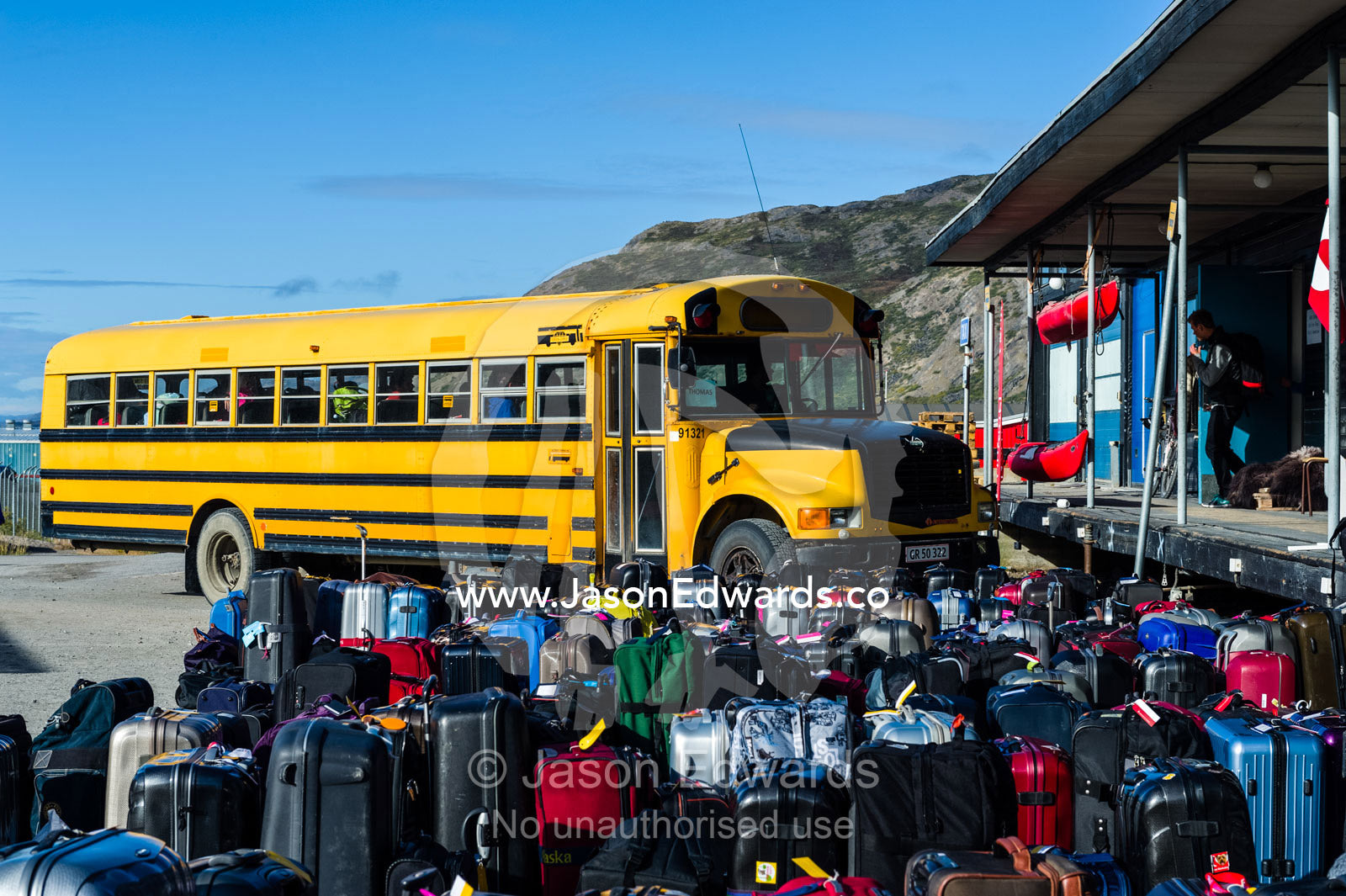 Airport baggage waiting to be loaded onto a bus for passengers. Kangerlussuaq, Qeqqata Municipality, Greenland.