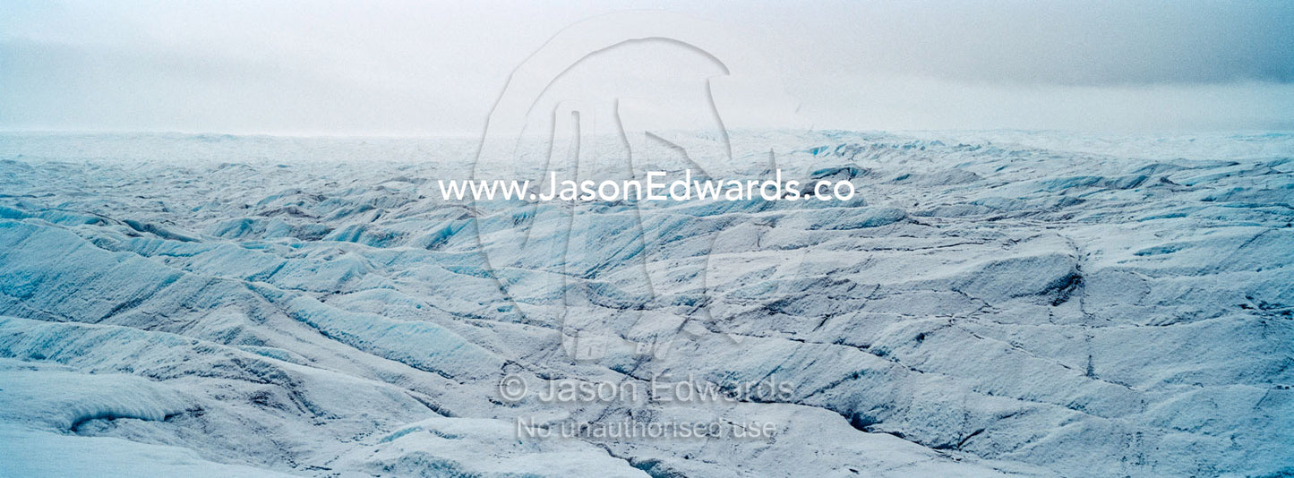 The frozen and barren wasteland of folded ice on the surface of the Greenland Ice Sheet. Greenland Ice Sheet, Qeqqata Municipality, Kangerlussuaq, Greenland.