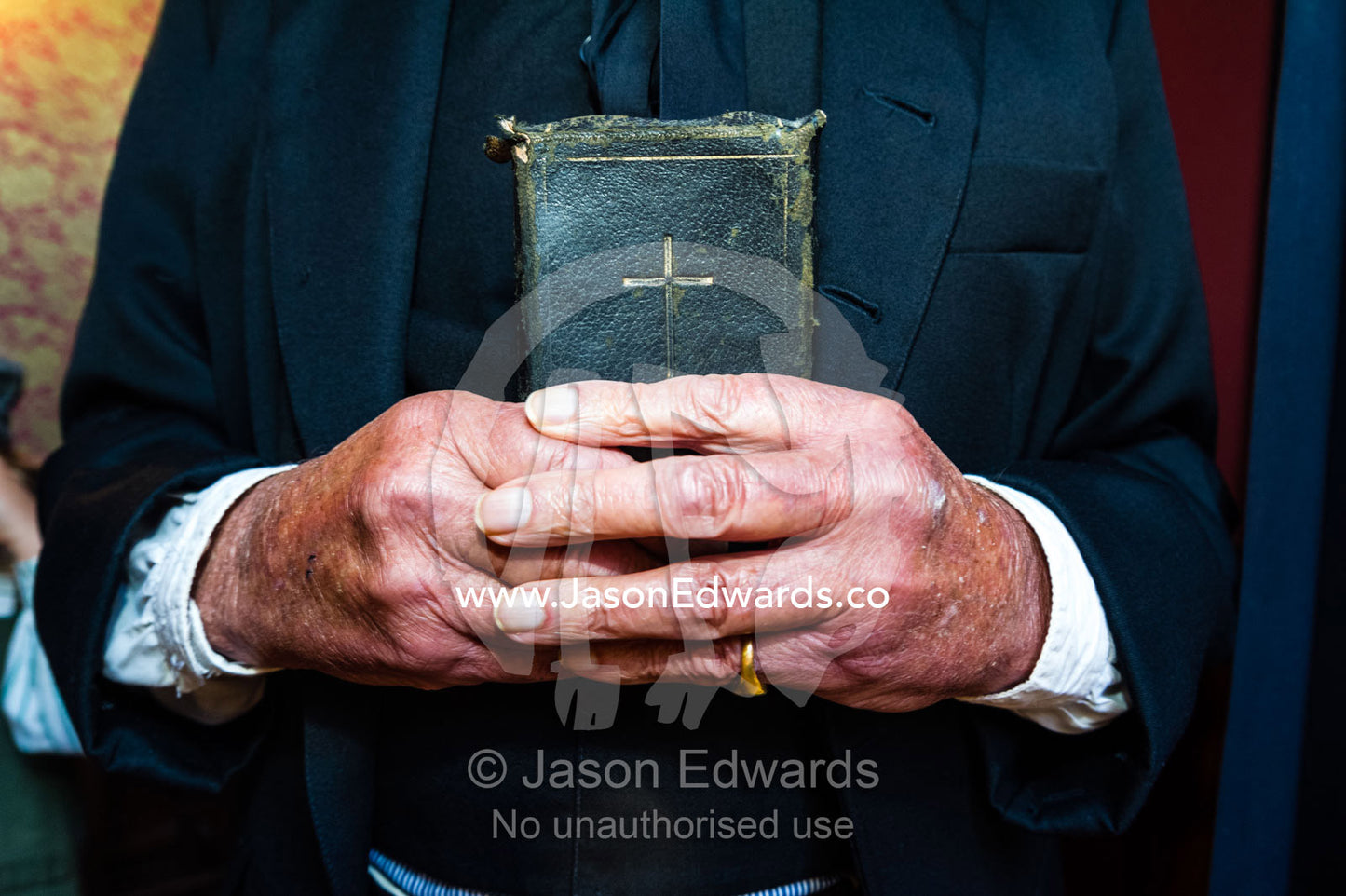 A visitor to a gold town museum dresses as a pastor to have a souvenir period drama photograph taken. Sovereign Hill, Ballarat, Victoria, Australia.