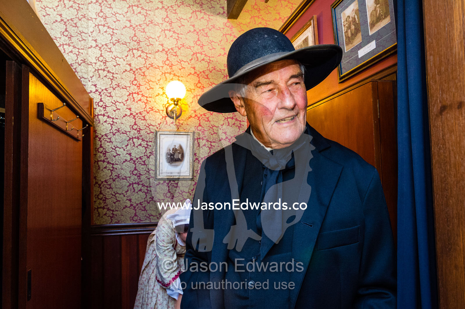 A visitor to a gold town museum dresses as a pastor to have a souvenir period drama photograph taken. Sovereign Hill, Ballarat, Victoria, Australia.