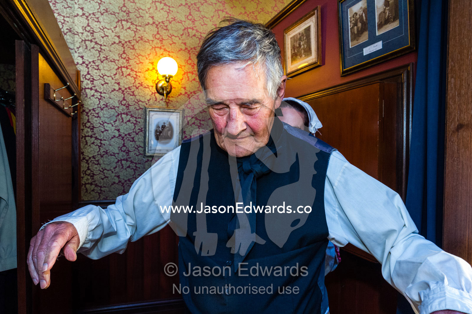 A visitor to a gold town museum dresses as a pastor to have a souvenir period drama photograph taken. Sovereign Hill, Ballarat, Victoria, Australia.
