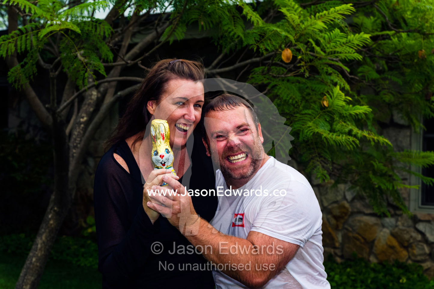 Friends share a chocolate Easter Bunny they found in the garden. Euroa, Strathbogie, Victoria Australia.