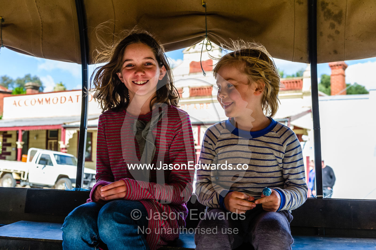 Friends waiting for a horse and cart ride in a country town. Maldon, Shire of Mount Alexander, Victoria, Australia.