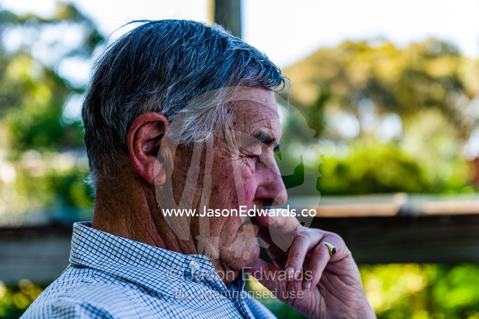 An elderly man rests on a shady balcony deep in thought. Castlemaine, Victoria, Australia.