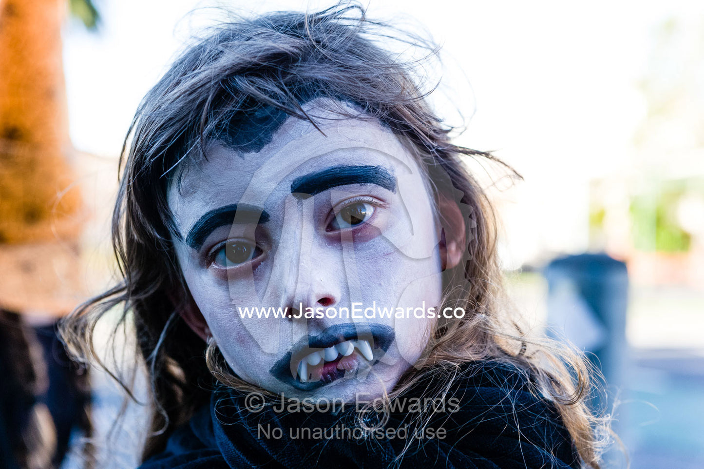 A girl dressed as a vampire with fangs on Halloween. Carlton North, Melbourne, Victoria, Australia.