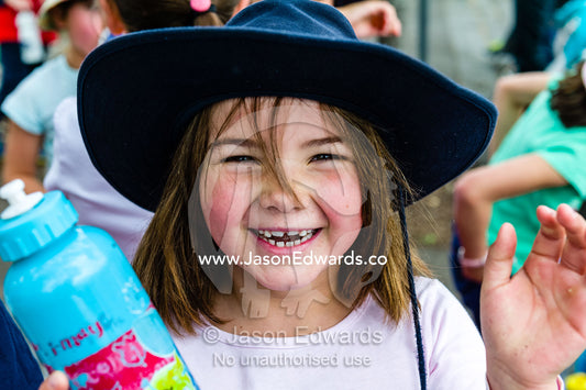 A girl with a water bottle during an elementary school fundraising walkathon. Carlton North Primary School, Melbourne, Victoria, Australia.