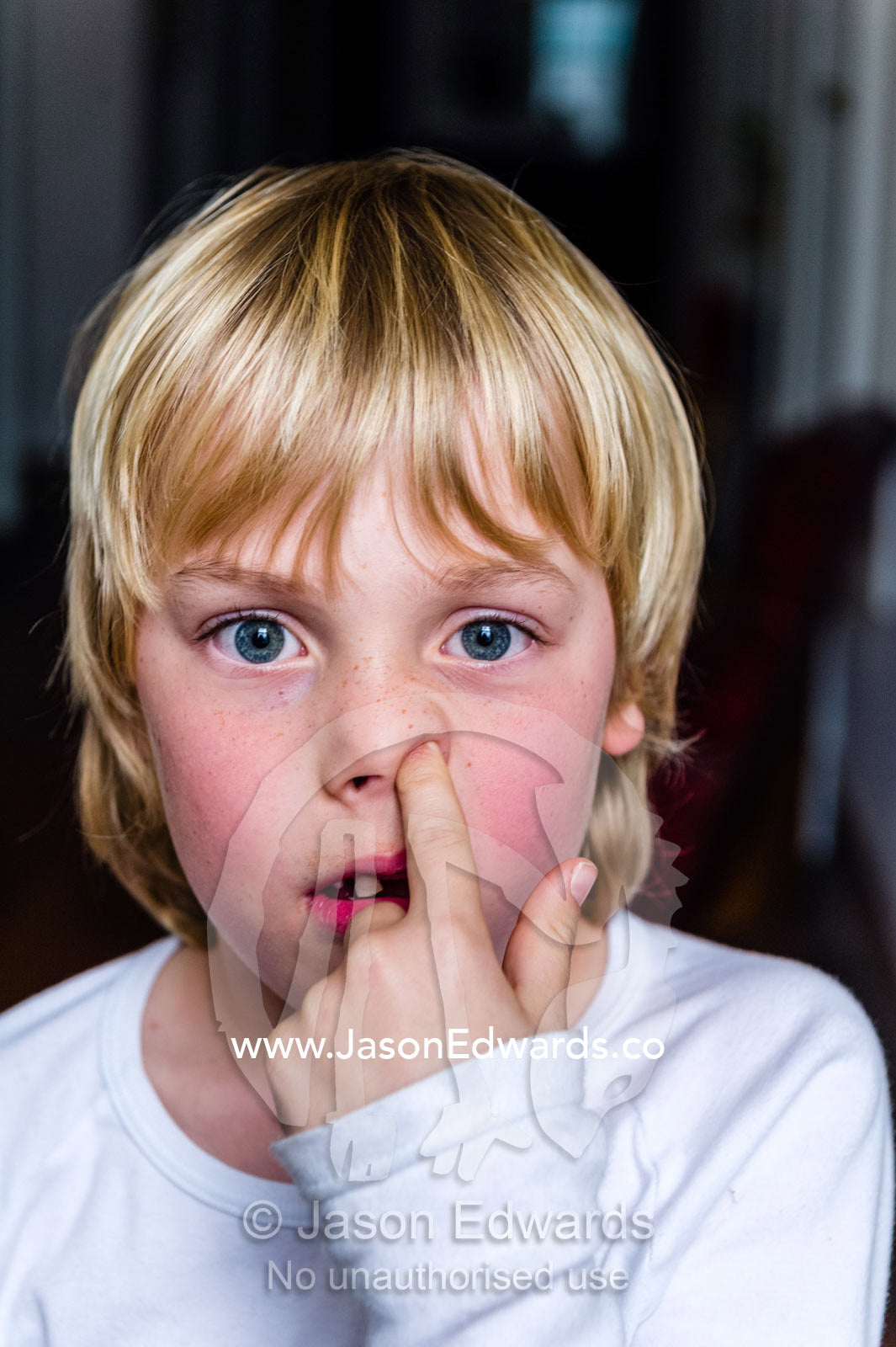 A boy picking his nose to capture boogies. Carlton North, Melbourne, Victoria, Australia.