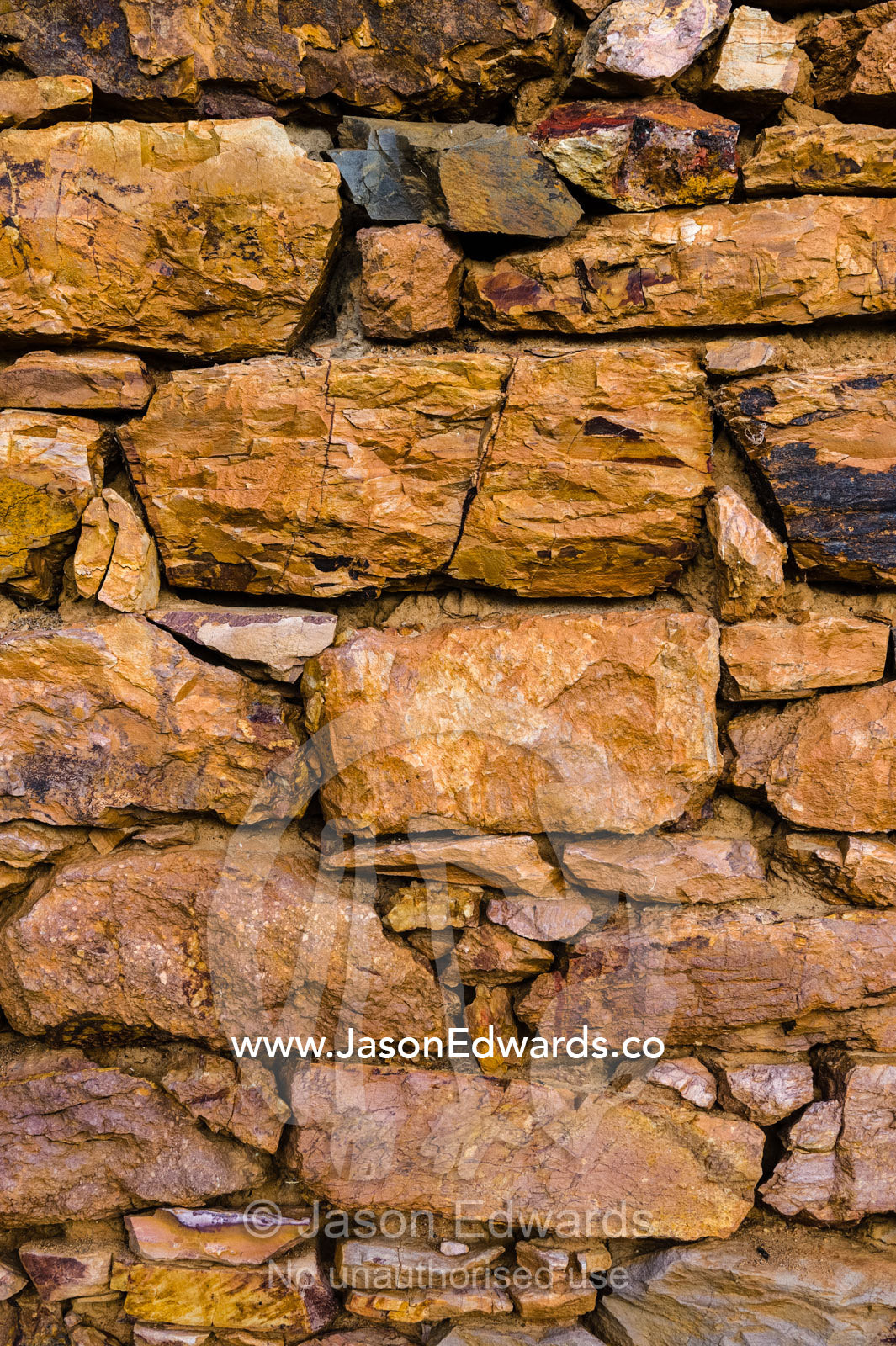 The stone wall of a 19th century grain storage shed built from locally quarried stones and timber. Faithfuls Creek Grain Storage, Euroa, Balmattum, Strathbogie, Victoria, Australia.