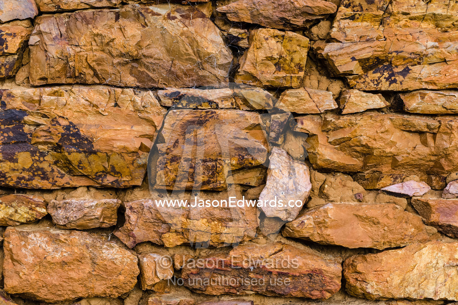 The stone wall of a 19th century grain storage shed built from locally quarried stones and timber. Faithfuls Creek Grain Storage, Euroa, Balmattum, Strathbogie, Victoria, Australia.