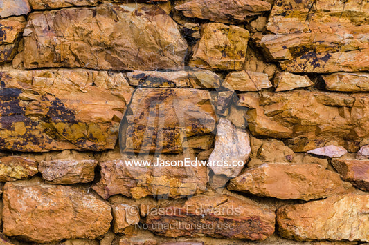 The stone wall of a 19th century grain storage shed built from locally quarried stones and timber. Faithfuls Creek Grain Storage, Euroa, Balmattum, Strathbogie, Victoria, Australia.
