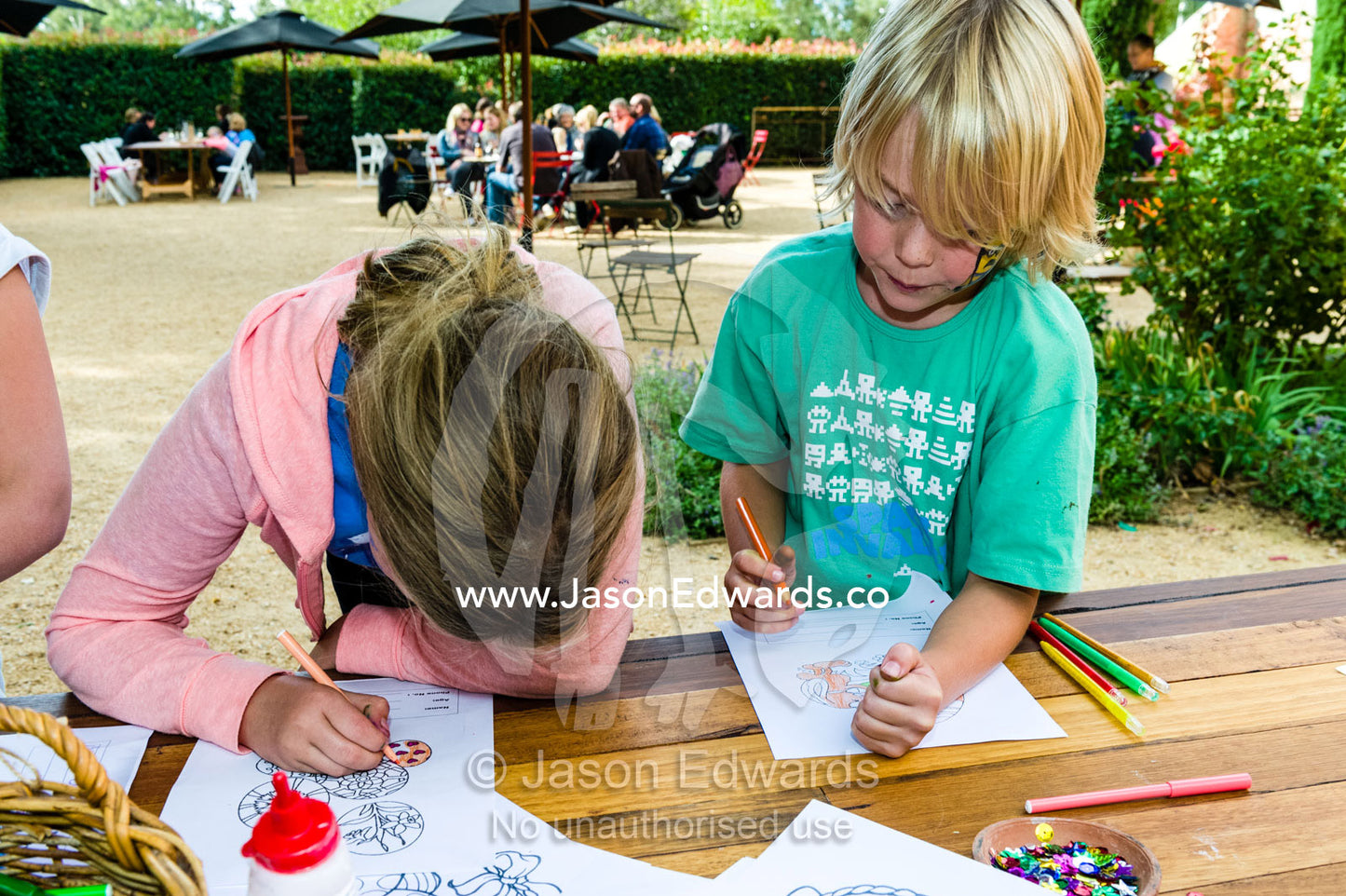 Friends working diligently on pictures in an Easter coloring competition. Euroa Butter and Ice Factory, Euroa, Strathbogie, Victoria, Australia.