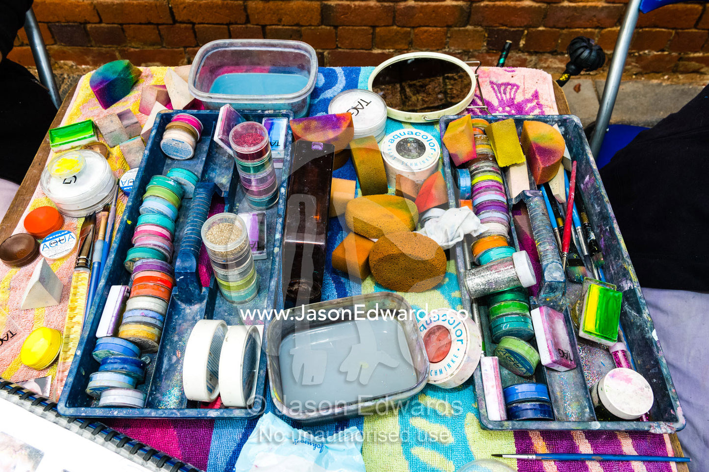A face painting kit with paints and brushes at an Easter carnival. Euroa Butter and Ice Factory, Euroa, Strathbogie, Victoria, Australia.
