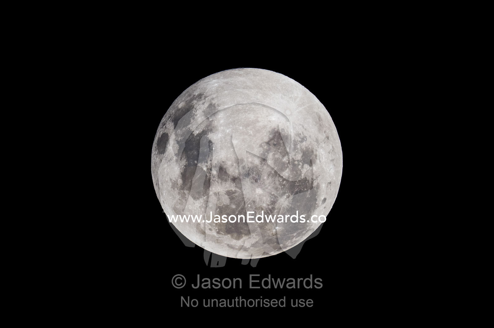 A shadow passes across the face of a full moon during an eclipse. Carlton North, Melbourne, Victoria, Australia.