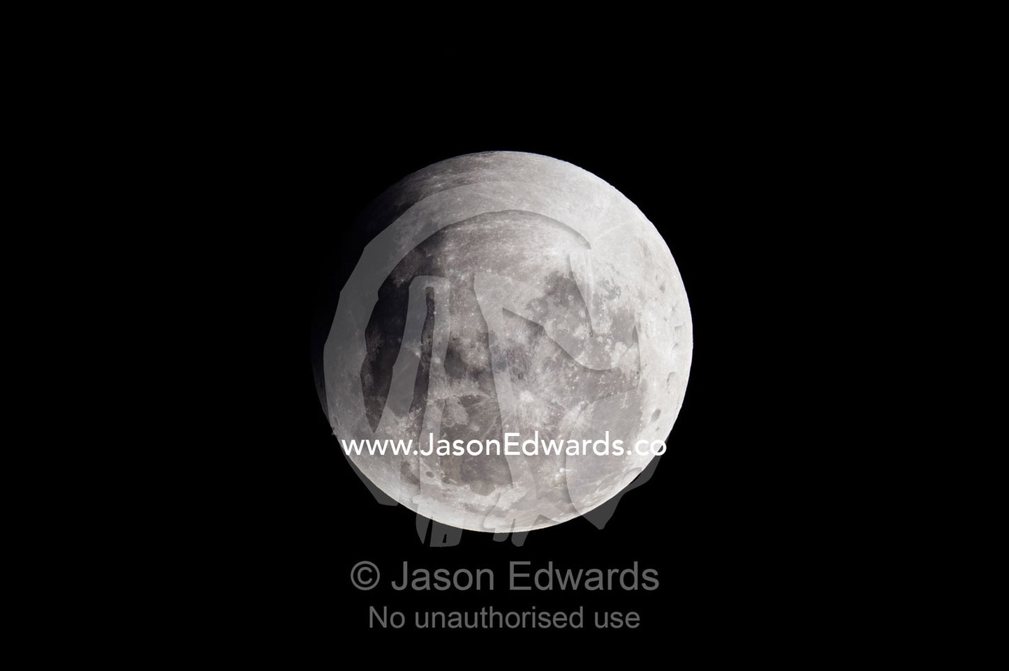 A shadow passes across the face of a full moon during an eclipse. Carlton North, Melbourne, Victoria, Australia.