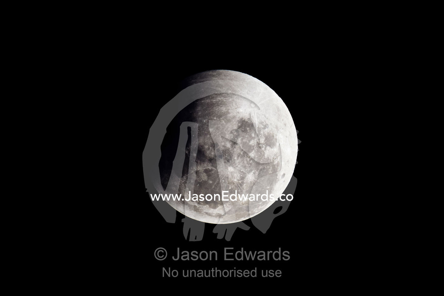 A shadow passes across the face of a full moon during an eclipse. Carlton North, Melbourne, Victoria, Australia.
